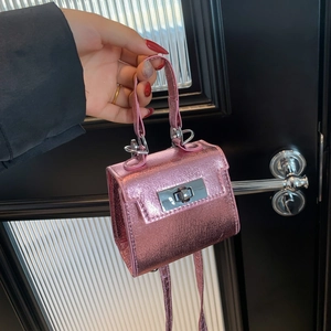 Mini pink metallic crossbody bag with silver rotating lock for stylish women's decor