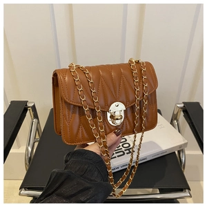 Détail du sac bandoulière en similicuir marron avec surpiqûres en V et fermoir doré