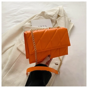 Detailed view of the bright orange quilted PU leather flap bag with gold chain strap