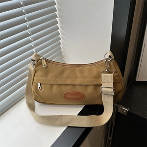Minimalist camel canvas crossbody bag for women with wide fabric strap and fashion label