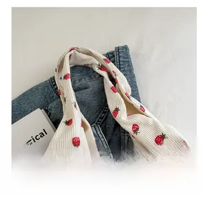 Détail du sac fourre-tout en velours côtelé blanc avec imprimé fraise et anse large