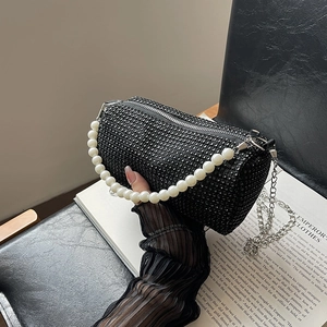 Black crystal-studded cylinder bag with white pearl handle and silver chain strap