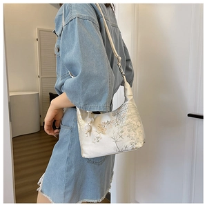 Close-up of silk fabric texture with traditional Chinese floral embroidery on the bag