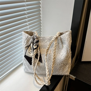 Cream tote bag with daisy floral embroidery, braided handles and decorative silk scarf