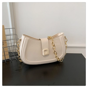 Close-up of cream PU leather shoulder bag with gold chain strap and square buckle