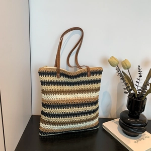 Rainbow woven tote bag with striped pattern and leather handles for beach or casual use