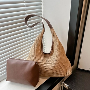 Minimalist straw tote bag set with brown leather straps and inner pouch for beach travel