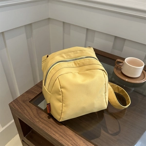 Bright yellow lightweight nylon shell crossbody bag with a trendy puffy design and shoulder strap