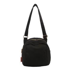 Lightweight black nylon shell crossbody bag with adjustable strap and gold dual zippers