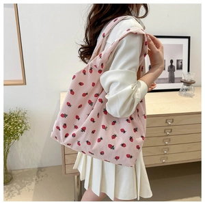 Detail of light pink corduroy tote bag featuring strawberry print and large capacity