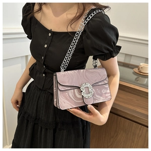 Detail of purple marble pattern shoulder bag with crystal buckle and silver chain