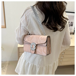 Close-up of pink marble pattern shoulder bag featuring a crystal square buckle detail