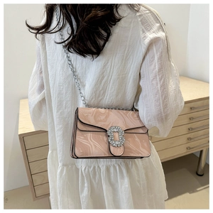 Detailed view of pink marble pattern crossbody bag with rhinestone buckle and chain
