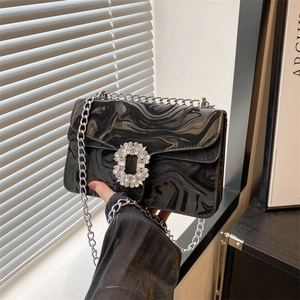 Elegant black marble textured crossbody bag with rhinestone buckle and silver chain