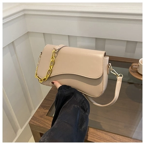Detail view of beige crescent flap bag with premium smooth leather and gold chain