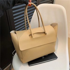 Minimalist beige leather tote bag with top handle and spacious interior for daily commute