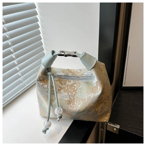 Detail of light green silk bag with gold mountain embroidery and silver metal buckle