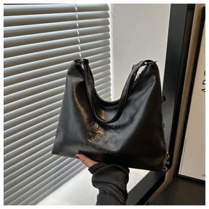 Detail of black large bucket bag with embossed MUDOU COLO letters and side metal chain