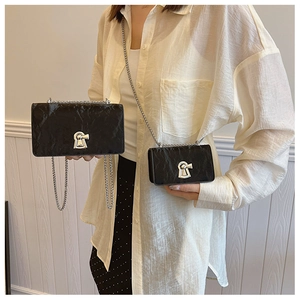 Size comparison between medium and small black chain bags with textured faux leather finish