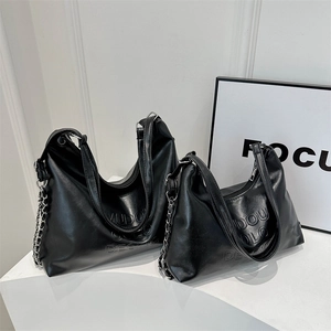 Minimalist black leather bucket bag set with embossed logo and silver chain details