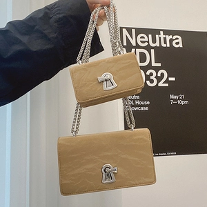 Vintage khaki chain bag set with pleated leather texture shown in a hand-held pose