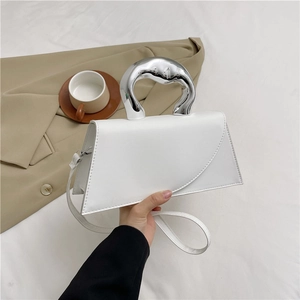 Minimalist white trapezoid handbag with sculptural silver metal handle and shoulder strap