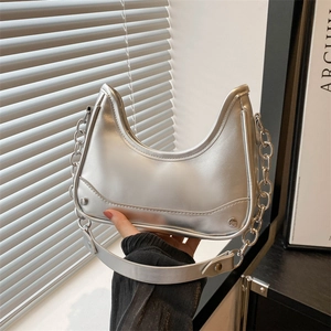 Chic silver crescent saddle shoulder bag with metallic finish and dual strap design