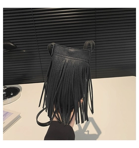 Close-up of black lychee grain leather phone bag with long fringe tassels and thin strap