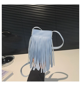 Detail of light blue fringe crossbody bag with litchi texture and elegant long tassels