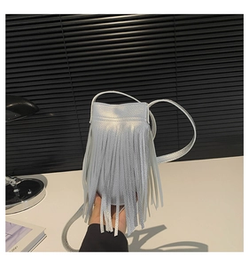 Close-up of metallic silver fringe phone bag with long tassels and slim shoulder strap