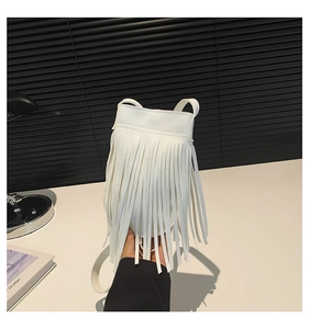 Close-up of white tassel crossbody phone bag featuring lychee grain synthetic leather