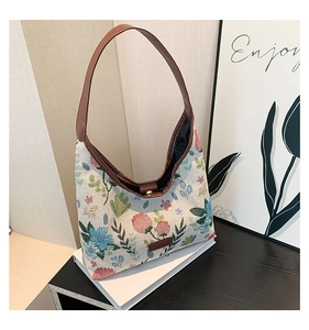 Detailed view of vintage floral jacquard fabric tote bag with brown leather strap