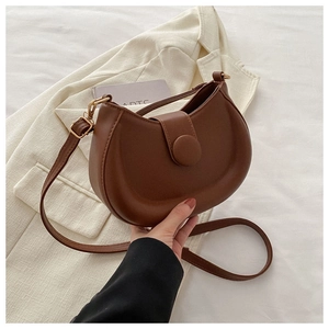 Detailed side view of a brown semi-circle PU leather shoulder bag with a gold buckle