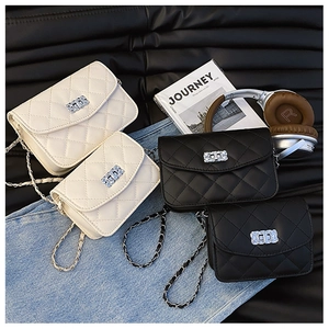 Detail of quilted flap crossbody bags featuring metal chain straps and rhinestone locks