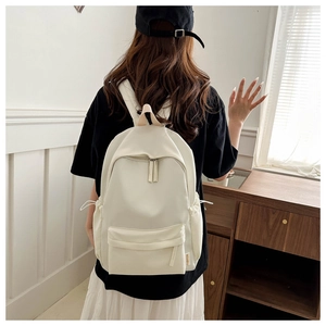 Detailed close-up of fashion backpack in cream white with stylish side drawstring pockets