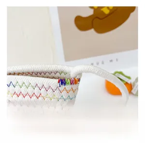 Close-up of white woven cotton bag showing colorful rainbow wavy stitching details