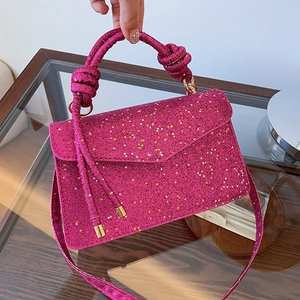 Fuchsia sequin handbag with fuchsia knotted handle and star accents, shown from the front