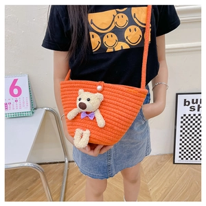 Detail of orange woven mini bag for girls with cute teddy bear and pearl buckle
