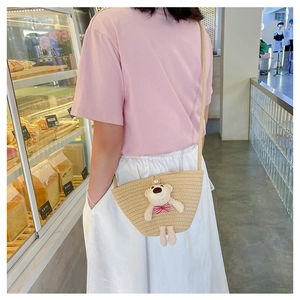 Detailed view of mini woven crossbody bag with cute teddy bear and pearl button detail