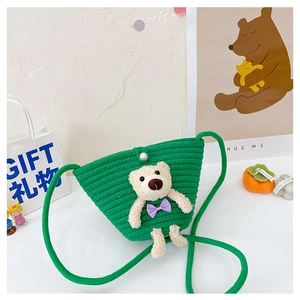 Detail of green knitted kids crossbody bag with 3D plush bear and pearl button closure