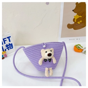 Detail of purple woven crossbody bag for kids featuring a plush bear and pearl button
