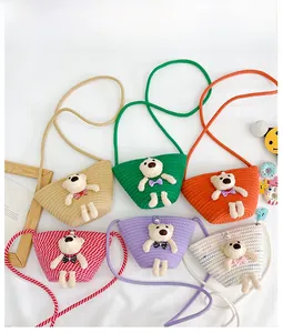 Detailed flat lay of colorful woven mini bags featuring 3D plush bear charms for kids