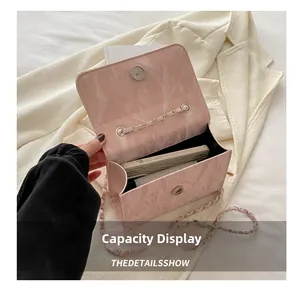 Detail view of the pink marble textured flap bag showing interior capacity for a smartphone