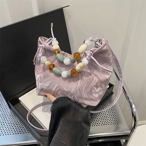 Purple marble pattern pleated bucket bag with beaded handle and crossbody strap