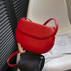 Minimalist red saddle bag in matte PU leather with flap closure and adjustable shoulder strap