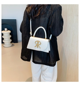 White PU leather small square bag shown as crossbody style on a model with gold hardware