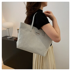 Large capacity grey canvas tote bag with leather strap and metal buckle detail