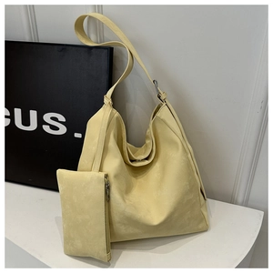 Detail of light yellow hobo bag with matching small coin pouch in soft matte finish