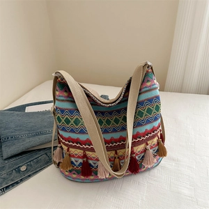 Bohemian woven tote bag with colorful geometric patterns and decorative tassels