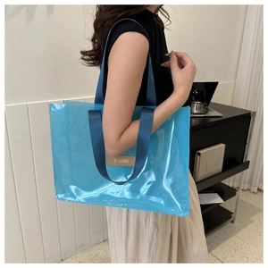 Close-up of a blue semi-transparent waterproof cosmetic tote bag with durable woven straps